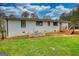 Exterior view of backyard featuring mature trees, a wooden deck and a fence at 1910 Reese Rd, Rutledge, GA 30663
