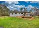 Picture of the backyard with green grass, mature trees and a deck at 1910 Reese Rd, Rutledge, GA 30663