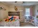 A charming bedroom featuring a rustic wood headboard and a playful arrangement of stuffed animals at 1910 Reese Rd, Rutledge, GA 30663