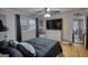 A spacious bedroom featuring hardwood floors, a large TV, and abundant natural light at 1910 Reese Rd, Rutledge, GA 30663
