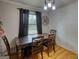 Traditional dining room with a wooden table, chairs, and a view of the backyard at 1910 Reese Rd, Rutledge, GA 30663