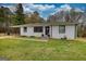 Charming home featuring white brick, black trim, lovely lawn, and covered parking at 1910 Reese Rd, Rutledge, GA 30663