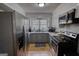 A kitchen featuring stainless steel appliances, granite countertops, and ample natural light at 1910 Reese Rd, Rutledge, GA 30663