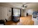 Bright living room boasts hardwood floors, large windows, and access to the dining area at 1910 Reese Rd, Rutledge, GA 30663