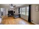 Cozy living room with hardwood floors, a ceiling fan, and a large window with natural light at 1910 Reese Rd, Rutledge, GA 30663