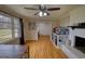 Bright living room boasts hardwood floors, large windows, a fireplace, and ceiling fan at 1910 Reese Rd, Rutledge, GA 30663