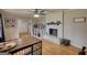 Spacious living room features a white brick fireplace, hardwood floors, and ceiling fan at 1910 Reese Rd, Rutledge, GA 30663