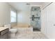 Bright bathroom featuring a glass shower and a large soaking tub with white cabinets at 4180 Pineset Dr, Alpharetta, GA 30022
