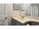 A bathroom with a large mirror, and a sink with grey cabinets and with a doorway next to it at 4180 Pineset Dr, Alpharetta, GA 30022