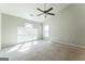 Spacious bedroom with carpet, vaulted ceiling, fan, and bright windows at 4180 Pineset Dr, Alpharetta, GA 30022