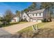 Two-story home with a long driveway, a two car garage, and a well-manicured lawn at 4180 Pineset Dr, Alpharetta, GA 30022