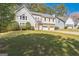 Charming two-story home boasts a manicured lawn and a two-car garage at 4180 Pineset Dr, Alpharetta, GA 30022