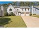 Charming two-story home with stone accents, attached two-car garage, and well-maintained lawn at 4180 Pineset Dr, Alpharetta, GA 30022