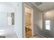 Hallway leading to bathroom with a stone fireplace and bedroom entrance with great view at 4180 Pineset Dr, Alpharetta, GA 30022