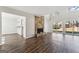Bright living room with a stone fireplace, hardwood floors, and sliding glass doors at 4180 Pineset Dr, Alpharetta, GA 30022