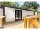 The wooden deck featuring sleek black metal railings and access to the interior through glass patio doors at 2145 Venesa Cir, Austell, GA 30168