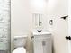 Elegant bathroom features a white vanity, square mirror, and modern black hardware at 2145 Venesa Cir, Austell, GA 30168