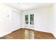 Bright bedroom features hardwood floors, double doors to deck and closet with white shutter doors at 2145 Venesa Cir, Austell, GA 30168