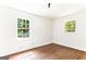 Bright bedroom featuring two windows and hardwood flooring, creating an inviting space at 2145 Venesa Cir, Austell, GA 30168