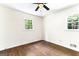 Bedroom featuring hardwood floors, ceiling fan and two windows at 2145 Venesa Cir, Austell, GA 30168