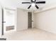 Cozy bedroom with ceiling fan, featuring a walk-in closet and an open doorway at 2145 Venesa Cir, Austell, GA 30168