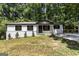 Charming single-story home featuring a brick foundation, black trim, and a newly landscaped yard at 2145 Venesa Cir, Austell, GA 30168