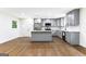 Modern kitchen with gray cabinets, stainless steel appliances, an island, and hardwood floors at 2145 Venesa Cir, Austell, GA 30168