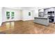 Bright kitchen featuring gray cabinets, stainless steel appliances, island, and hardwood floors at 2145 Venesa Cir, Austell, GA 30168