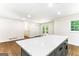 Bright kitchen area with island, stainless appliances, gray cabinets, hardwood flooring, and sliding doors at 2145 Venesa Cir, Austell, GA 30168