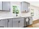 Bright kitchen area featuring gray cabinets, stainless steel appliances, hardwood floors, and modern fixtures at 2145 Venesa Cir, Austell, GA 30168