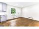 Spacious kitchen area with gray cabinets, hardwood floors, and natural light from a window at 2145 Venesa Cir, Austell, GA 30168