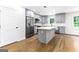 Kitchen features gray cabinets, stainless steel appliances, kitchen island, and hardwood flooring at 2145 Venesa Cir, Austell, GA 30168