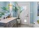Bathroom with painted vanity, mirror and access to the backyard at 2173 Conyers Se St, Covington, GA 30014