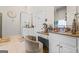 Bright bathroom featuring white cabinets, marble floors, makeup vanity, and a large, decorative clock at 2173 Conyers Se St, Covington, GA 30014