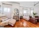 Bright and spacious bedroom with hardwood floors, ample seating, and large windows at 2173 Conyers Se St, Covington, GA 30014