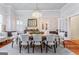 Spacious dining room with hardwood floors, chandelier, and unique wallpaper at 2173 Conyers Se St, Covington, GA 30014