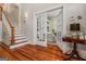 Foyer with stairway and view into room through French doors at 2173 Conyers Se St, Covington, GA 30014