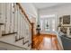 Bright foyer with hardwood floors, staircase, and elegant entry door with sidelights at 2173 Conyers Se St, Covington, GA 30014