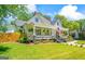 Picture perfect home with a cozy front porch, complemented by vibrant greenery and a well-manicured lawn at 2173 Conyers Se St, Covington, GA 30014