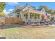 Charming home with an inviting front porch, lush landscaping, and classic architectural details at 2173 Conyers Se St, Covington, GA 30014