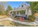 Charming home with an inviting front porch, lush landscaping, and classic architectural details at 2173 Conyers Se St, Covington, GA 30014