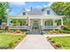 Charming home featuring a wide front porch, lush landscaping, and an inviting walkway to the front door at 2173 Conyers Se St, Covington, GA 30014