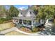 Charming home with an inviting front porch, lush landscaping, and classic architectural details at 2173 Conyers Se St, Covington, GA 30014