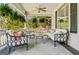 Inviting front porch with comfortable seating, ceiling fan, and lush greenery at 2173 Conyers Se St, Covington, GA 30014