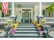 Inviting front porch adorned with colorful potted plants, offering a warm welcome and a glimpse of southern charm at 2173 Conyers Se St, Covington, GA 30014