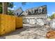 A three-car garage with white doors sits behind a partial wooden fence at 2173 Conyers Se St, Covington, GA 30014