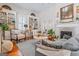 Bright living room features a decorative fireplace, bookshelves, and ample seating at 2173 Conyers Se St, Covington, GA 30014