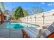 A full shot of the swimming pool, white fence, and outdoor lounge furniture at 2173 Conyers Se St, Covington, GA 30014