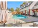 Backyard pool with concrete patio, white fence, and partial view of the home's exterior at 2173 Conyers Se St, Covington, GA 30014