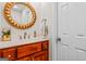 Updated powder room with a wood vanity, round mirror, and decorative accessories at 2173 Conyers Se St, Covington, GA 30014